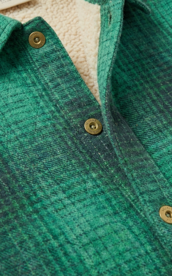 Closeup of button and sherpa lining on Boys Green Check Shacket, a childrens designer jackets pick