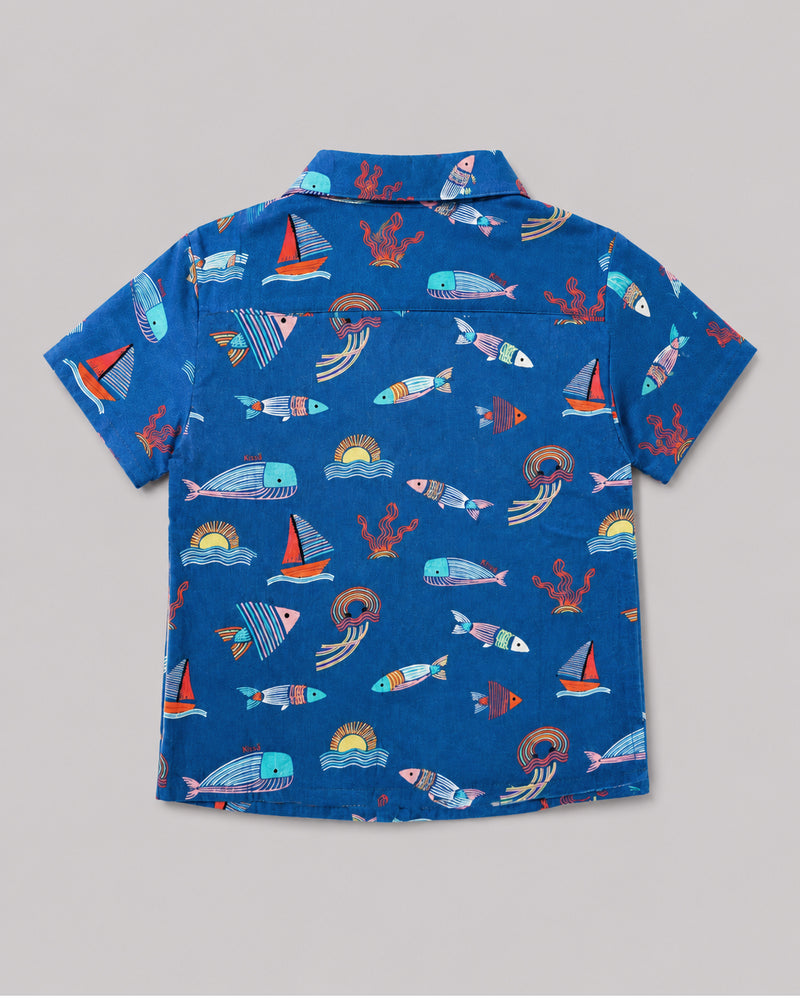 Boys ocean themed shirt in blue, sailboat and fish print, back view flat lay
