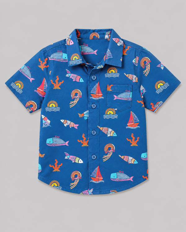 Boys ocean themed shirt in blue, sailboat and fish print, flat lay