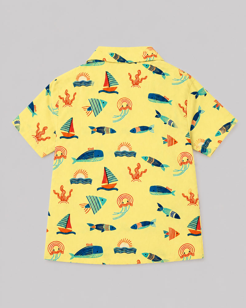 Back view of boys ocean themed shirt in yellow with sailboat and whale print, flat lay
