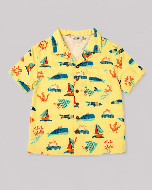 Boys ocean themed shirt in yellow with sailboat and whale print, flat lay
