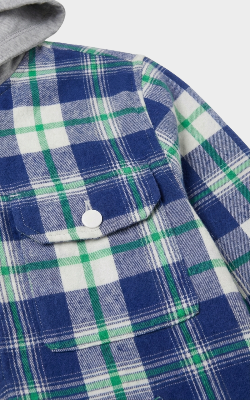 Closeup of snap-button pocket on Boys Green Blue Shacket, a childrens designer jackets pick