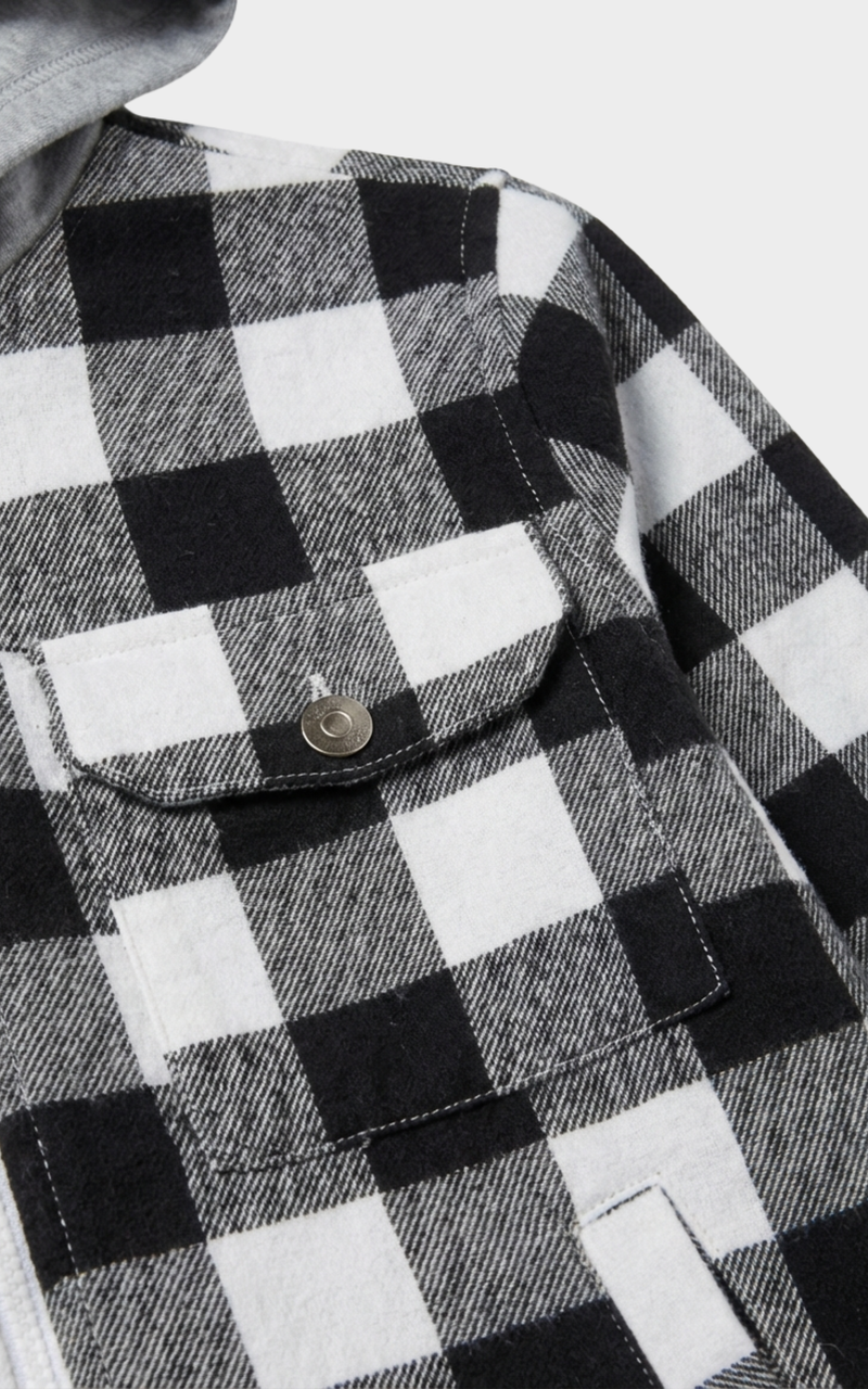 Closeup of snap-button pocket on Boys Black White Shacket, a childrens designer jackets pick