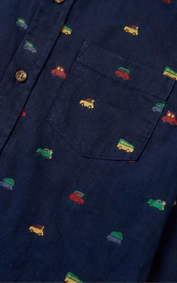 Closeup of car print pattern and pocket on Boys Navy Christmas Shirt, boys cotton shirts
