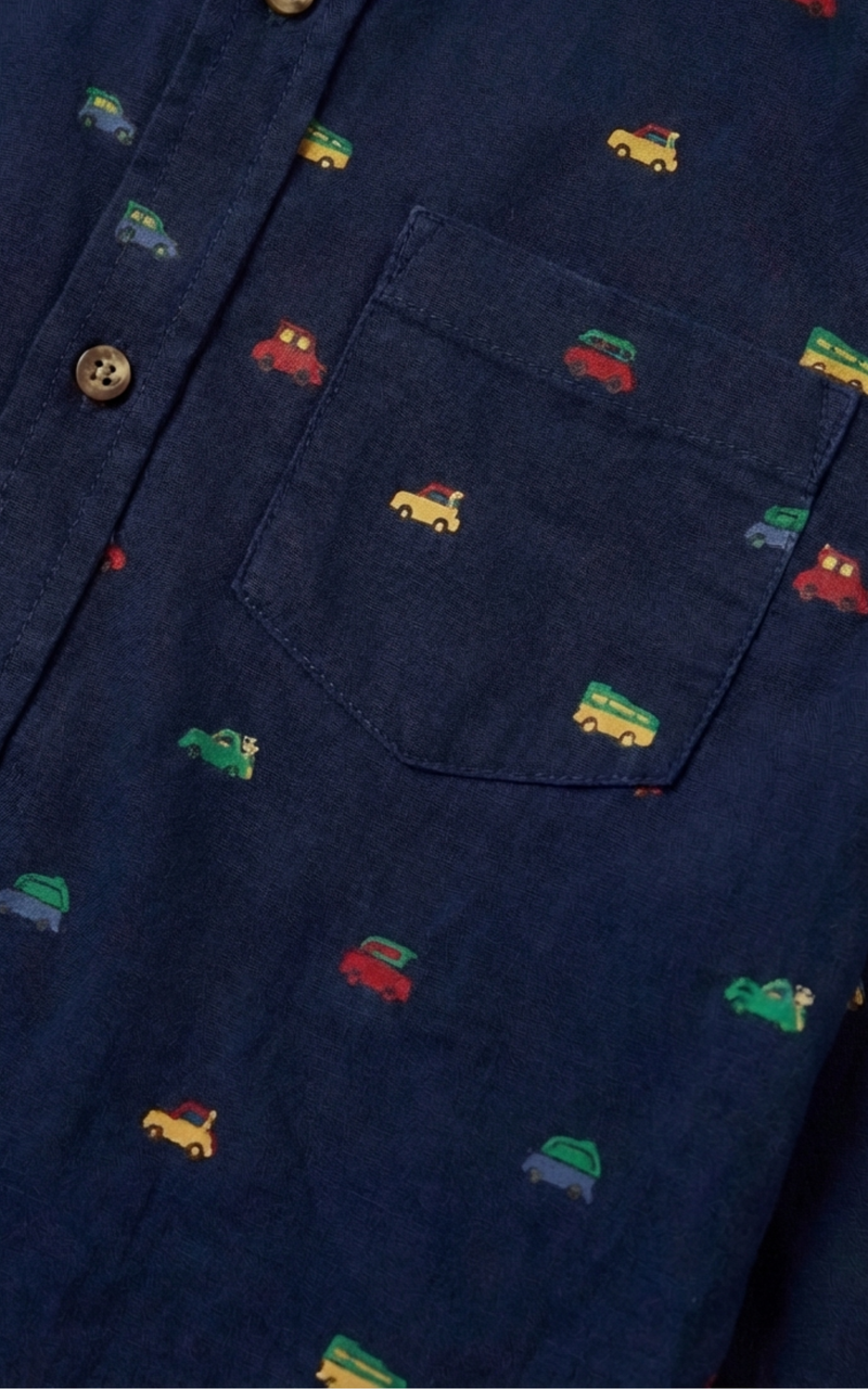 Closeup of car print pattern and pocket on Boys Navy Christmas Shirt, boys cotton shirts