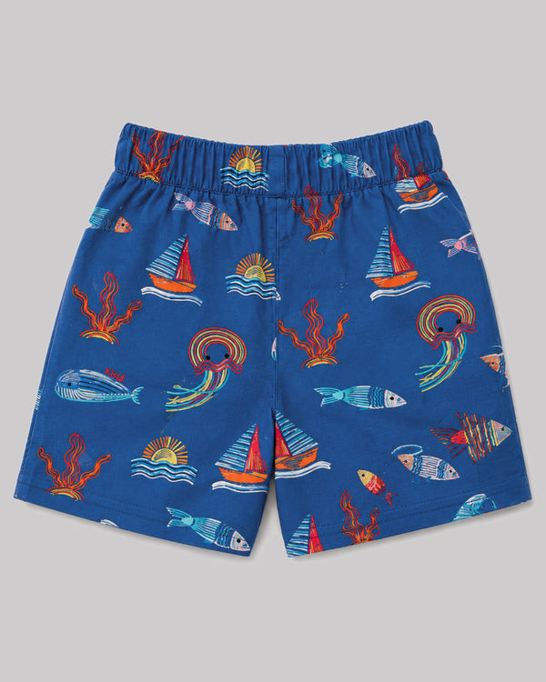 Boys ocean themed shorts in blue, sailboat and fish print, back view flat lay