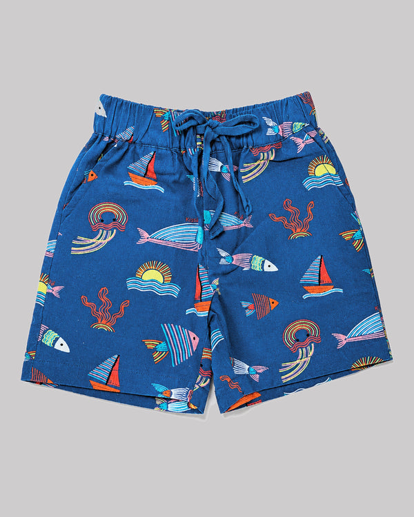 Boys ocean themed shorts in blue, sailboat and fish print, flat lay