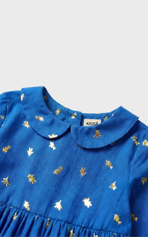 Closeup of Peter Pan collar and gold foil print on Girls Blue Dress, cute toddler girl dresses