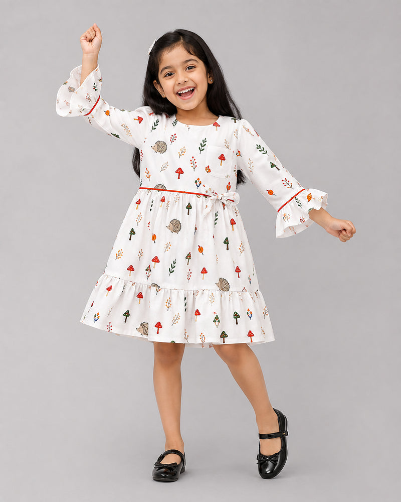 Laughing girl in mushroom print dress with ruffled bell sleeves, a fun baby girl dresses choice
