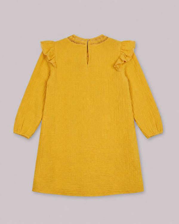 Back view of mustard yellow cotton dress with ruffle trim and keyhole closure, one of Kissa's dresses for girls