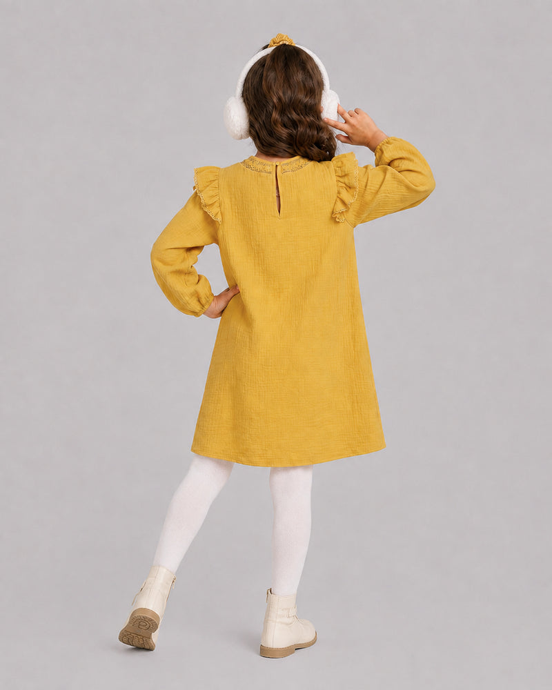 Girl in mustard yellow dress and white ear muffs, a warm baby girl dresses pick from behind