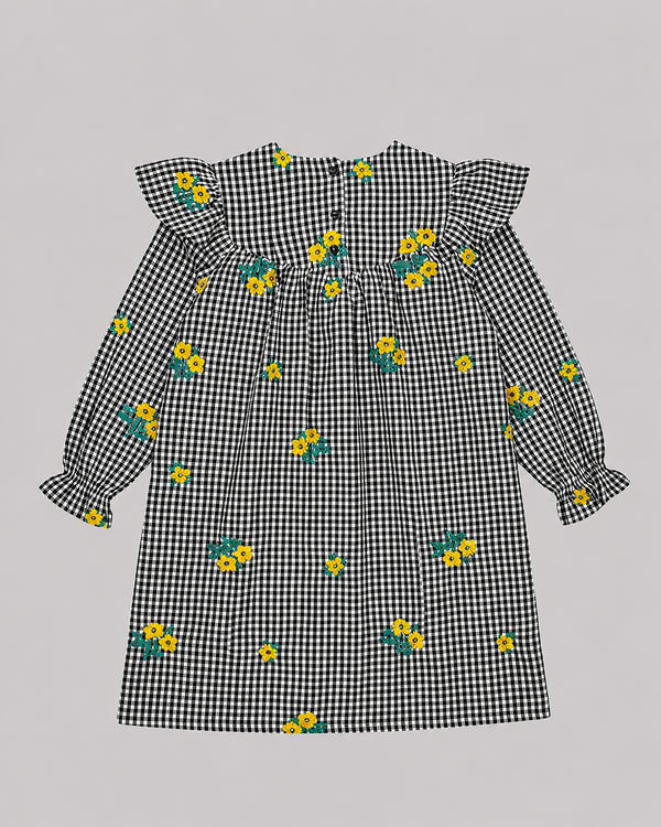 Back view of black and white gingham dress with yellow floral embroidery, one of Kissa's dresses for girls