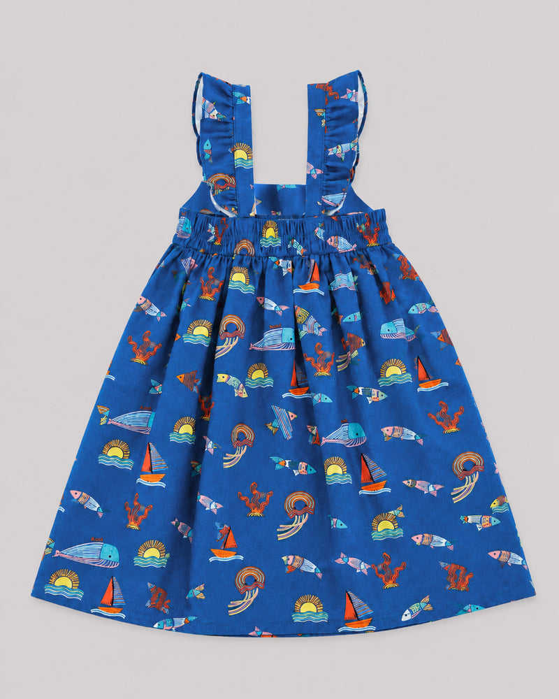 Back view of ocean themed dress for girls, blue with fish, whale, and sailboat print