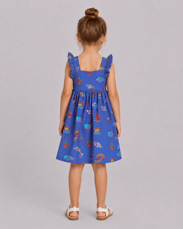 Back view of ocean themed dress for girls, blue nautical print with ruffle shoulder straps