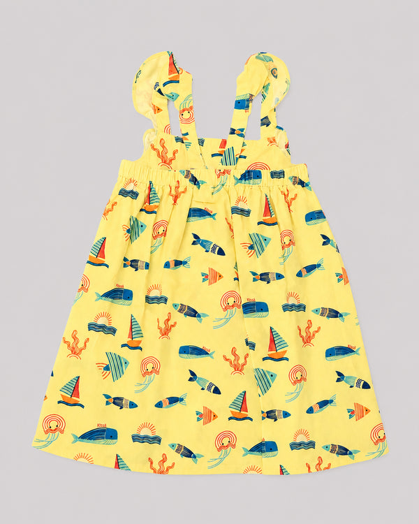 Girls ocean themed dress in yellow, sailboat and fish print, back view