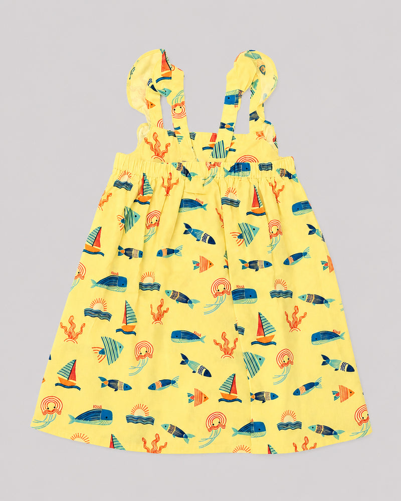Girls ocean themed dress in yellow, sailboat and fish print, back view