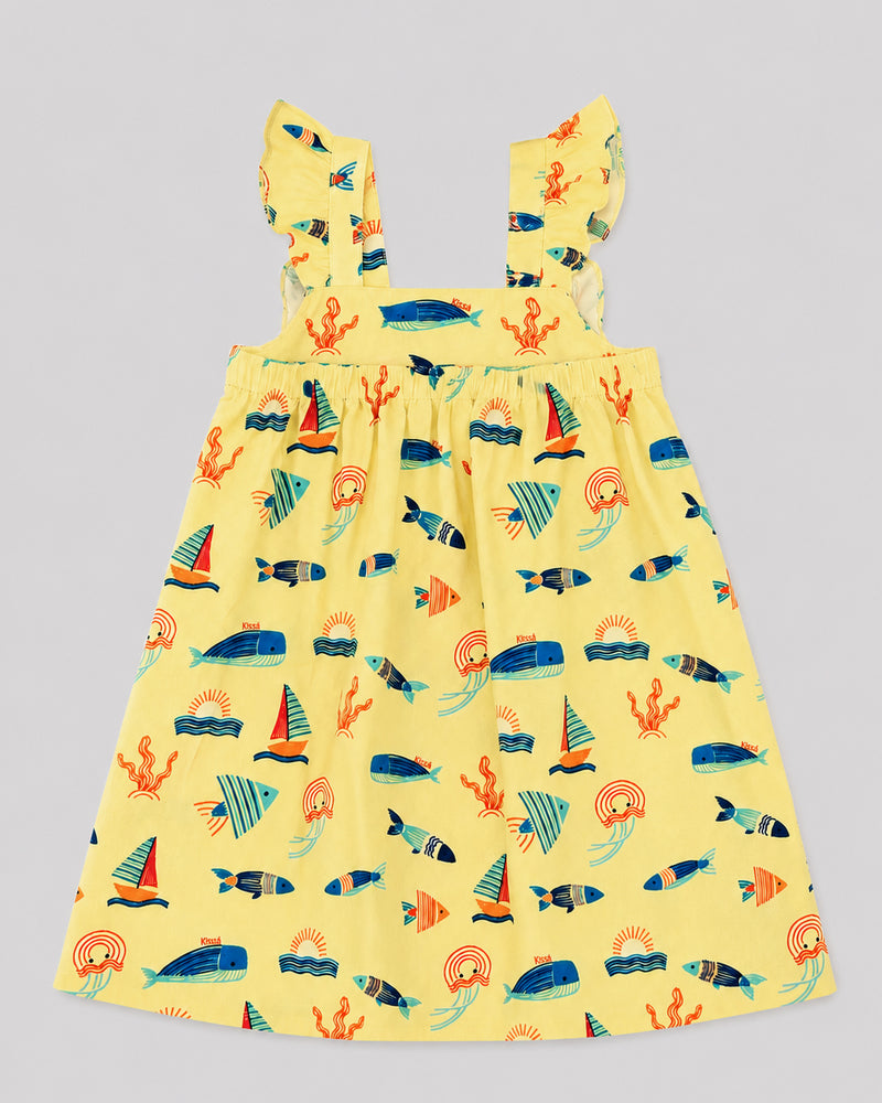 Girls ocean themed dress in yellow, sailboat and fish print, flat lay