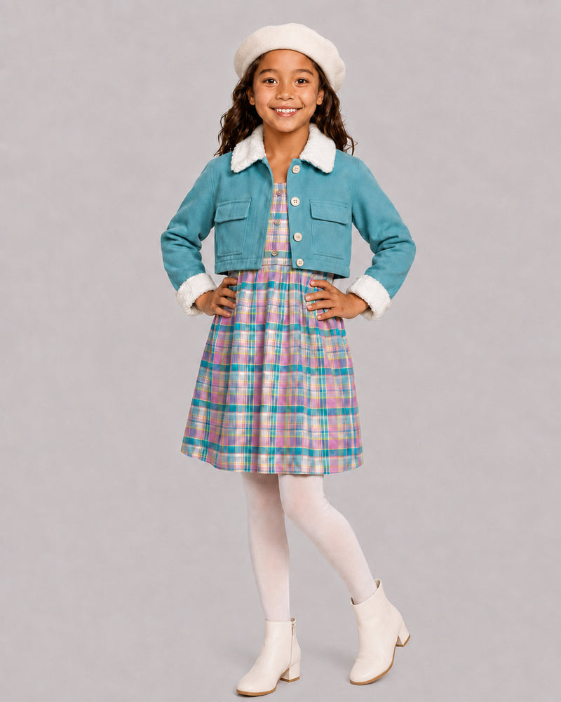 Smiling girl in teal fleece jacket and plaid dress, a warm girls winter coats style