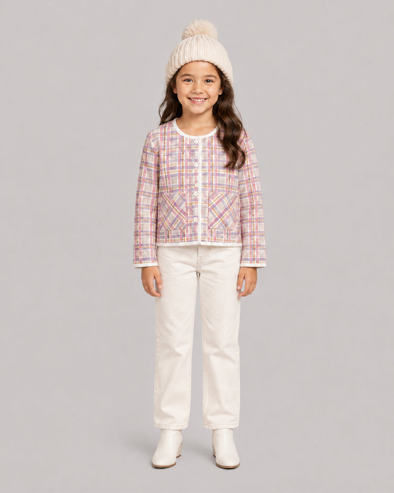 Smiling girl in pink tweed plaid jacket, cream jeans, and pom hat, a sweet toddler coat