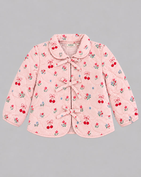 Flat lay of pink cherry print jacket with ribbon bow ties and Peter Pan collar, a charming toddler coat