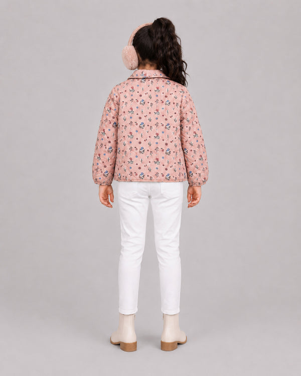 Girl in pink floral quilted jacket and fuzzy ear muffs, warm girls winter coats style from behind