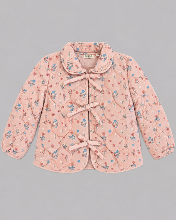 Flat lay of dusty pink floral jacket with ribbon ties and Peter Pan collar, one of Kissa's girls coats