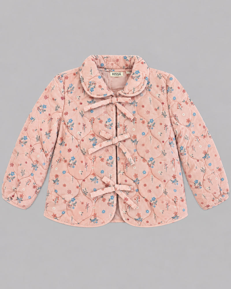 Flat lay of dusty pink floral jacket with ribbon ties and Peter Pan collar, one of Kissa's girls coats