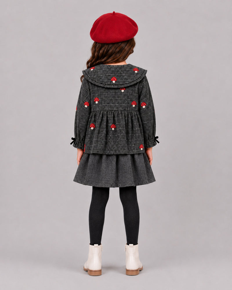 Girl wearing grey houndstooth mushroom top and skirt, back view of stylish girls fall outfits
