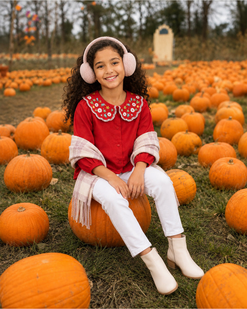 Girl wearing Red Embroidered Collar Girls Top and white jeans at a fall pumpkin patch photoshoot