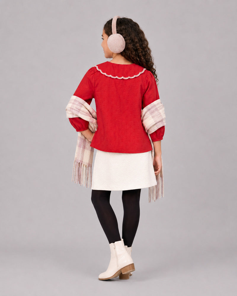 Girl styled in Red Embroidered Collar Girls Top paired with ivory tweed skirt, black tights and plaid scarf, back view