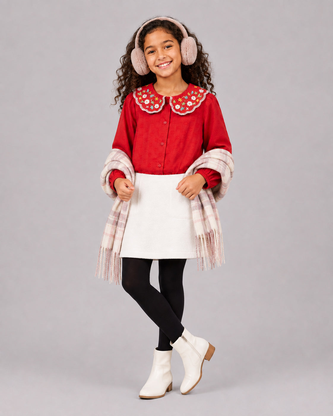 Smiling girl in Red Embroidered Collar Girls Top with white mini skirt, tights, earmuffs and plaid scarf